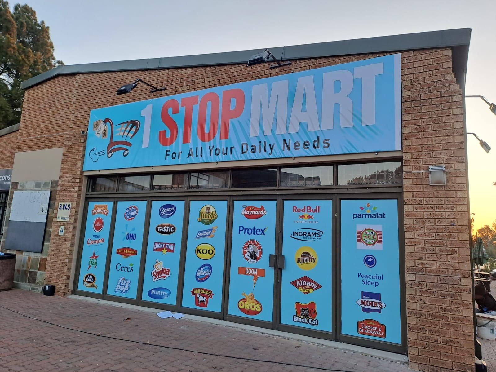 Stop Mart shopfront with a new fascia sign and branded window panels